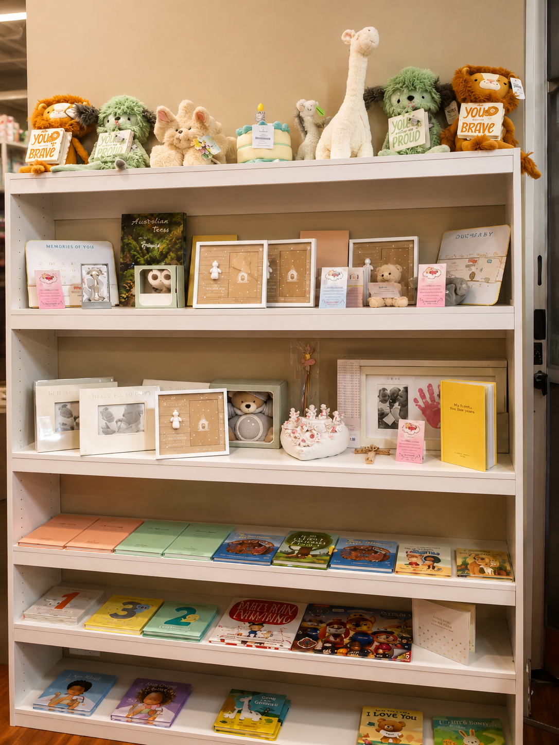 Shelves of plush toys, keepsake frames and children's books in store